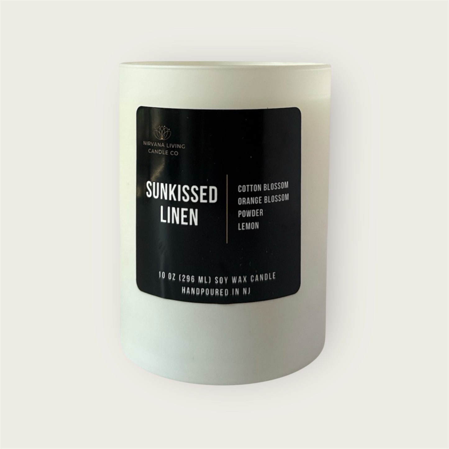 Handpoured soy candle with a clean linen scent in a white jar
